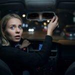 black-eyed child in rearview mirror at night